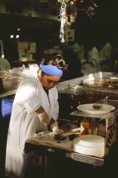 woman shucking oysters