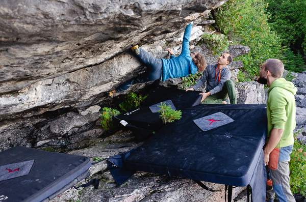 a woman climbing on the shore of lake huron