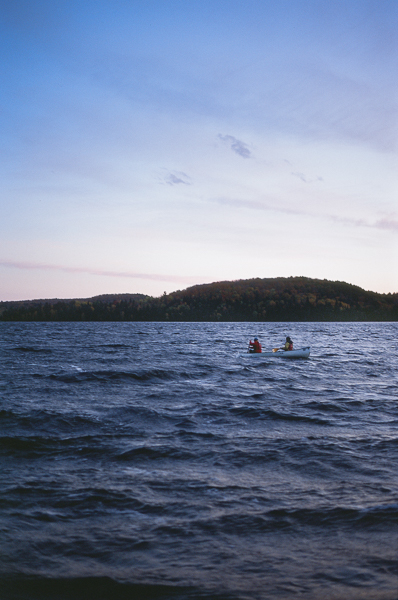 a canoe on a lake at dusk