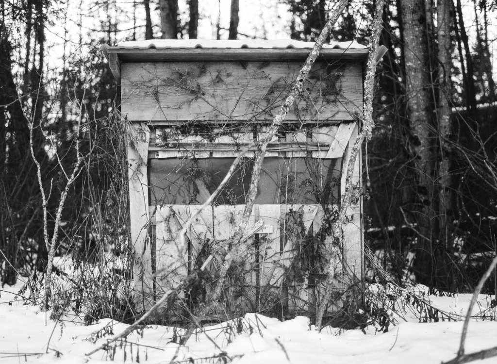 a black and white photo of a hunting shack in Maine