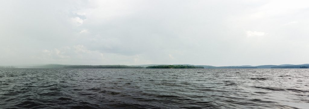 A panorama image of an island in a lake.