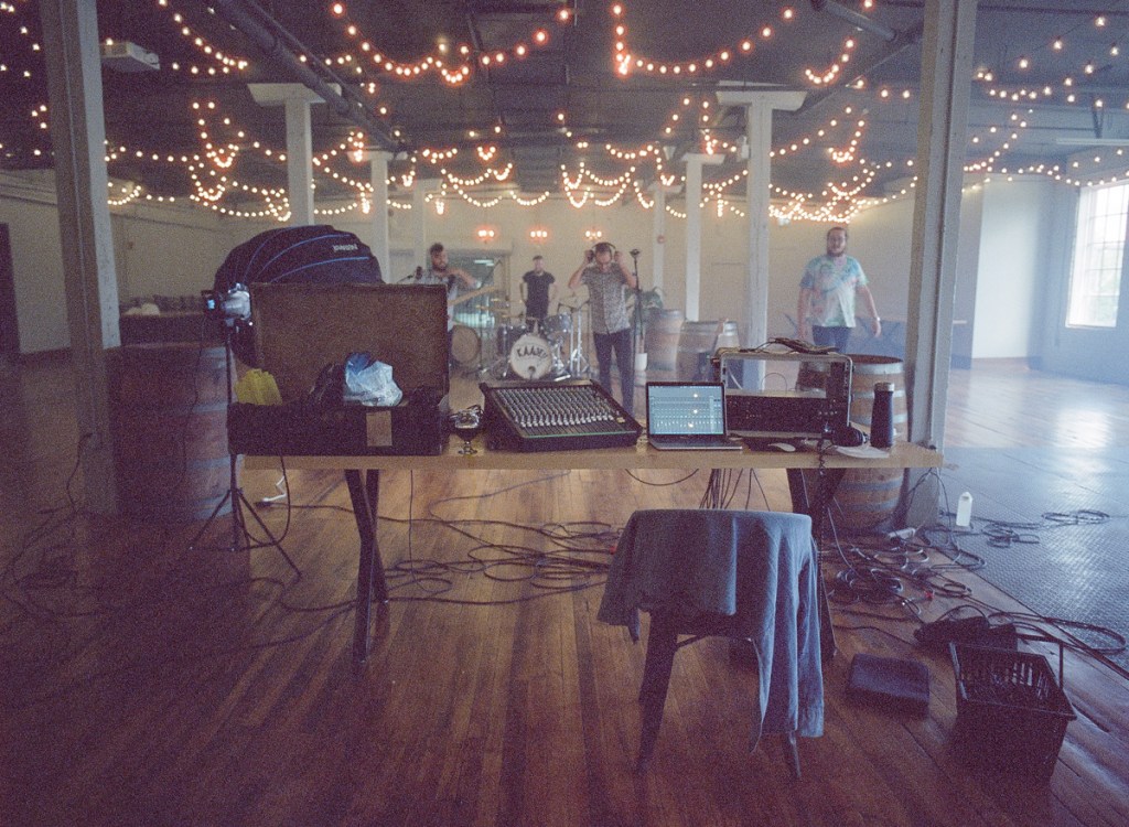 A picture of a rock band recording.