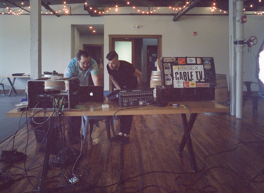 I picture of a rock band recording songs.