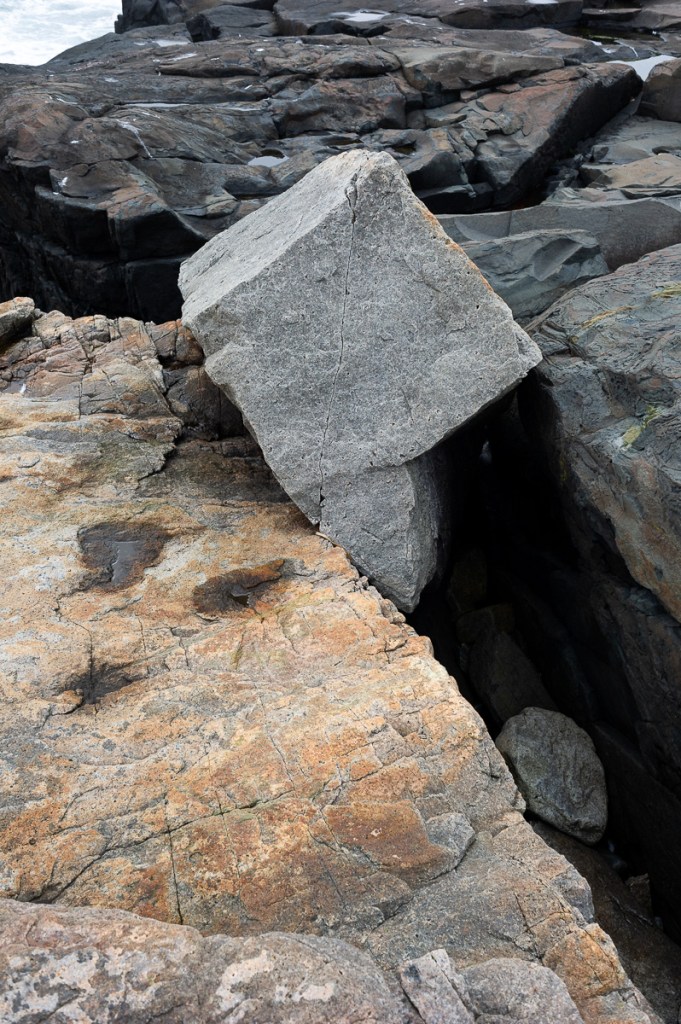 image of a boulder by the ocean