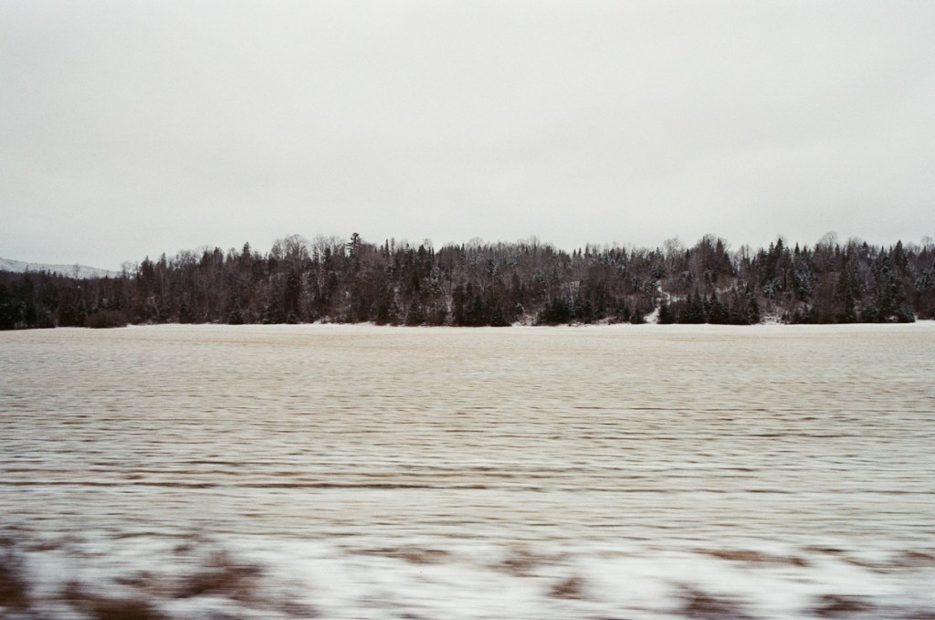 a snowy landscape shot from a moving car
