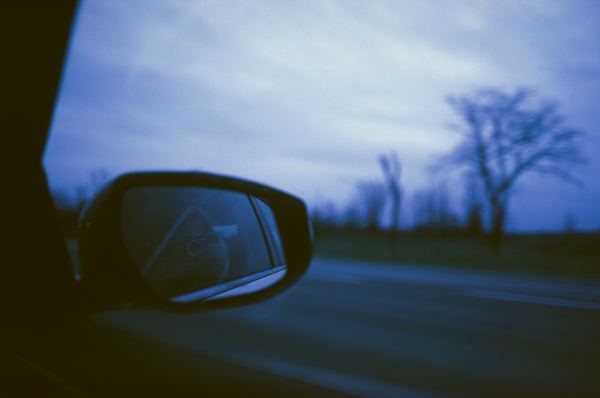 a landscape photo taken out the window of a moving car