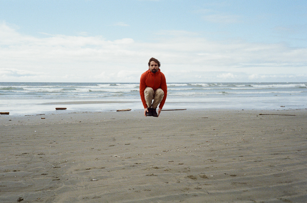 A snapshot of a man jumping on the beach