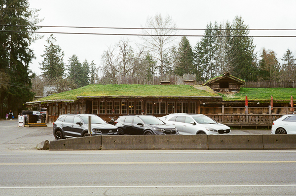 a landscape image of a building with a grassy roof