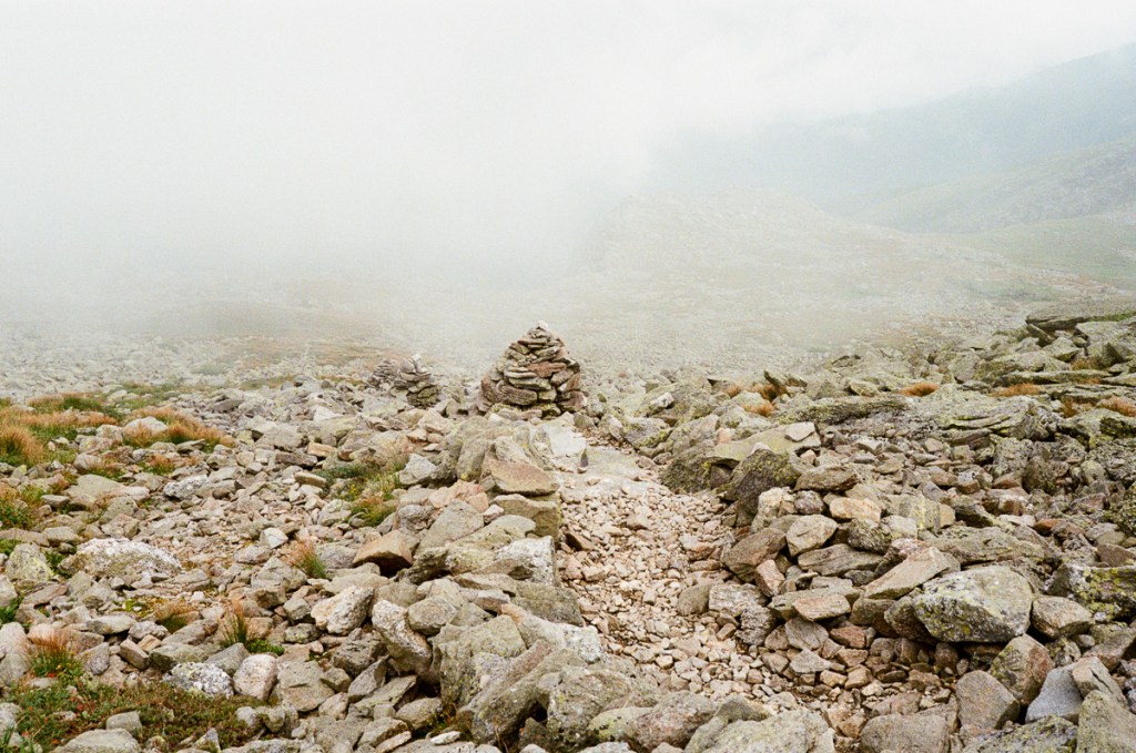 a landsape image of a mountain side with fog